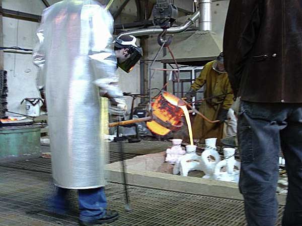 Pouring Bronze into Shell Mold